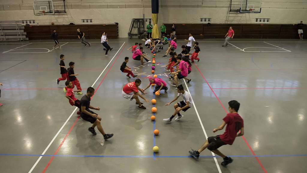 Students in team gym dodgeball tournament
