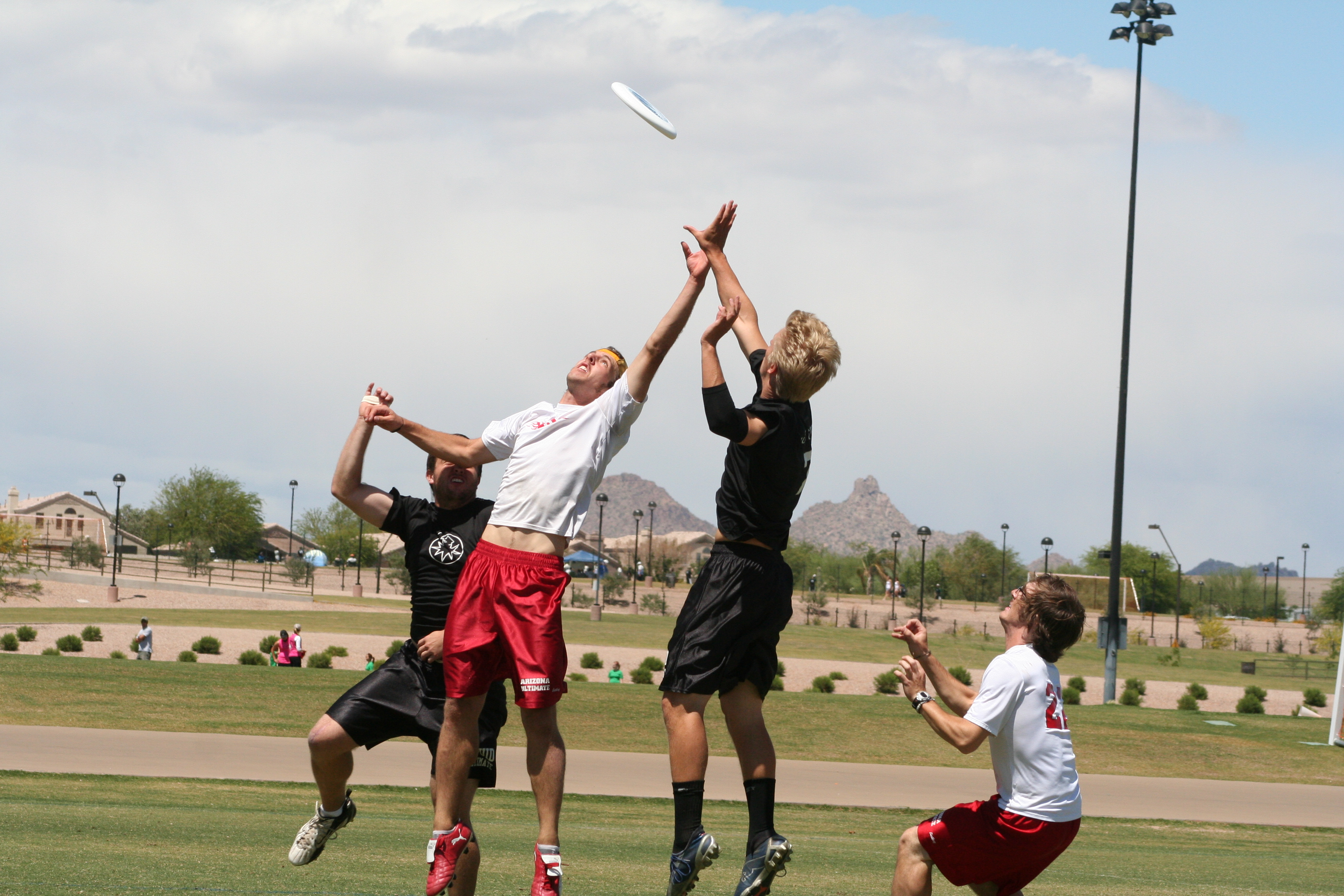 Ultimate frisbee jumping catch in outdoor field